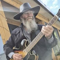 Billy Foreman, G-String sound engineer, playing guitar